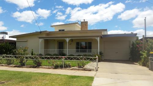 a house with a fence in front of it at City Holiday Home Mildura in Mildura