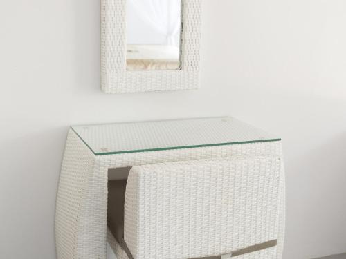a white shelf with a mirror on a wall at Moon Cottage in Choeng Mon Beach