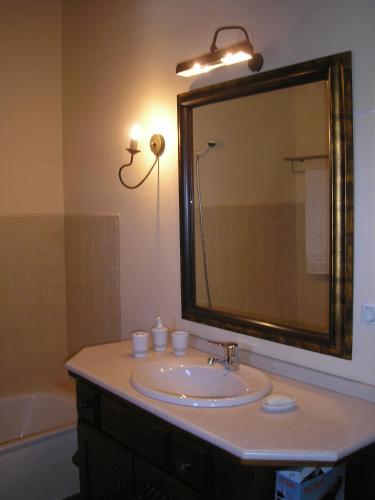a bathroom with a sink and a mirror and a tub at Casa da Silveirinha in Marvão
