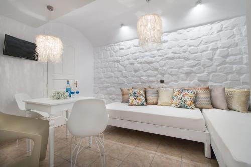 a living room with a white couch and a table at Spiros in Naxos Chora