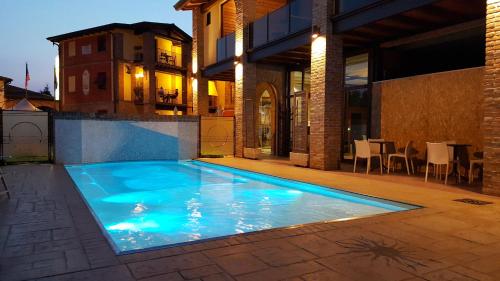 a swimming pool in the backyard of a house at Luna Residence Hotel in Casalmaggiore