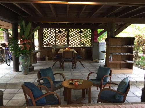 a patio with a table and chairs and a dining room at Bulunburi Resort in Ban Pong