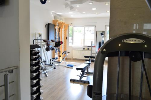 a gym with several tread machines in a room at Feel Belgrade Apartments in Belgrade
