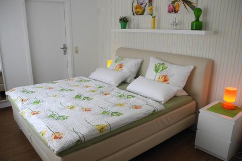 a bed with two pillows on it in a room at be Clemense in Sankt Aldegund