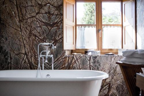 baño con bañera y ventana en La Bastide De Moustiers - Hôtel et Restaurant - Teritoria en Moustiers-Sainte-Marie