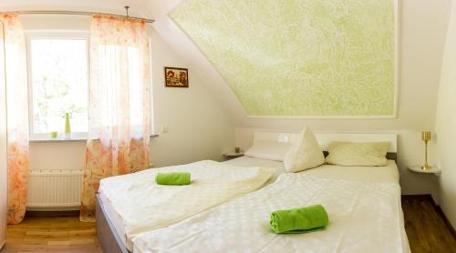 a bedroom with two beds with green towels on them at Suite mit Blick auf die Lichtentaler Allee in Baden-Baden