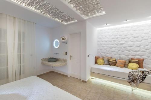 a white room with a couch with pillows on it at Spiros in Naxos Chora