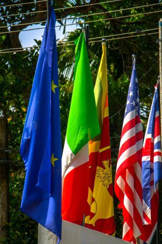 a group of different flags hanging on a line at Hotel La Felicita in Mirissa