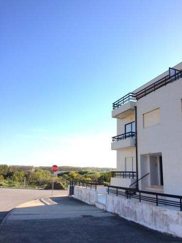 a building with a stop sign next to a street at Apartamento Praia Azul in Vila do Conde