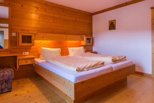 a bedroom with a bed in a wooden room at Haus Berner in Filzmoos