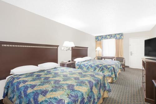 A bed or beds in a room at Super 8 by Wyndham Corpus Christi