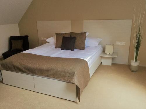 a bedroom with a large bed with white sheets and pillows at Hotel Astoria in Balatonfüred