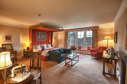 a large living room with a bed and a couch at Swinton Park in Masham