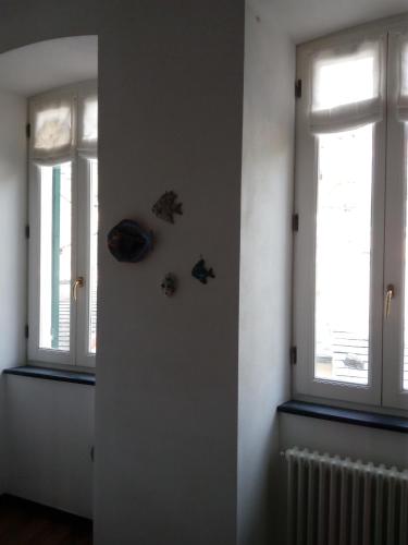 a room with two windows and a radiator at La Scala Vernazza CinqueTerre in Vernazza