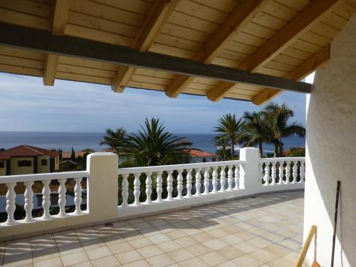 a white fence on a balcony with the ocean in the background at Studio - Casa Martin in San Sebastián de la Gomera