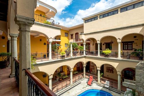 an image of a mansion with a swimming pool at Hotel CasAntica in Oaxaca City
