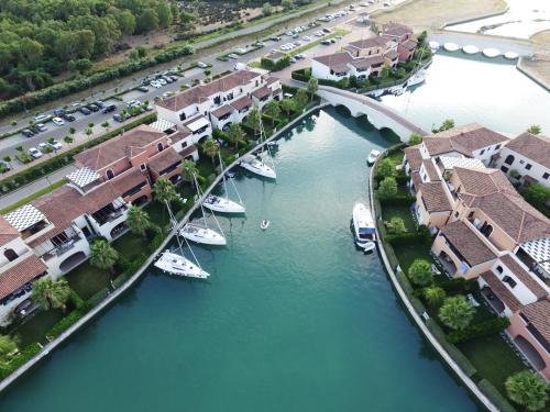 an aerial view of a river with houses and boats at Marinagri Resort in Policoro