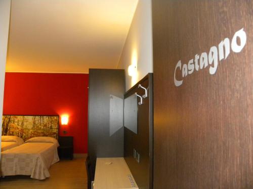 a hotel room with a bed and a sign on the wall at Il Boscaiolo Affittacamere in Preturo
