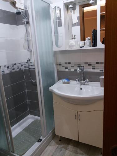 a bathroom with a sink and a shower at For Ever Apartments in Fiumicino