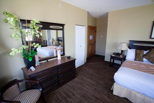a hotel room with a bed and a mirror at Days Inn by Wyndham Surrey in Surrey