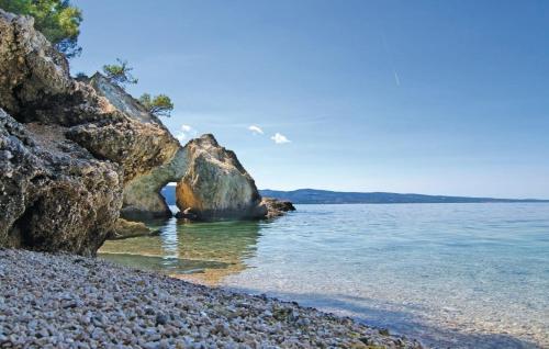 a beach with rocks and the water and the ocean at Apartments Coko in Omiš