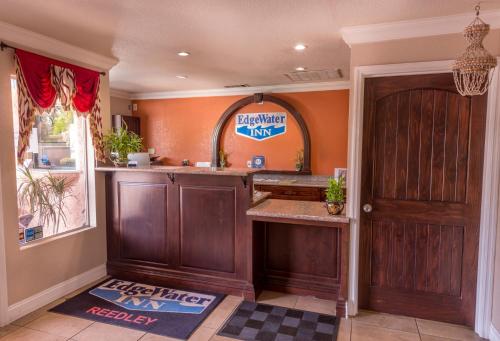 a kitchen with orange walls and a wooden door at Edge Water Inn in Reedley