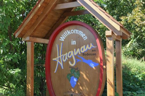 a wooden sign with a roof on top of it at FerienResidenz über'm See in Hagnau