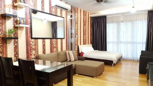 a living room with a couch and a bed at BEST KL City View at Regalia Residence in Kuala Lumpur