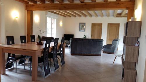 une salle à manger avec une table et des chaises en bois dans l'établissement Gite du Petit Potron, à Happonvilliers