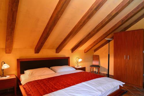 a bedroom with a large bed with a red blanket at Villa Nora Hvar in Hvar