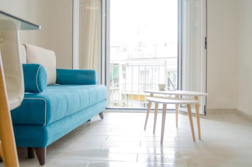 a blue couch and a table in a living room at Central Cozy Flat in Athens