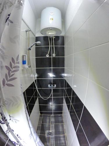 a bathroom with a black and white tiled shower at Studio Jegdic in Trebinje