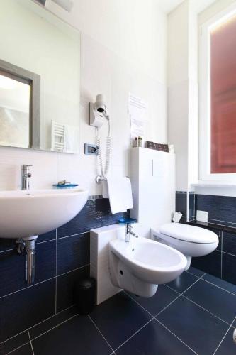 a bathroom with a white sink and a toilet at La Rosa Dei Venti in Monterosso al Mare