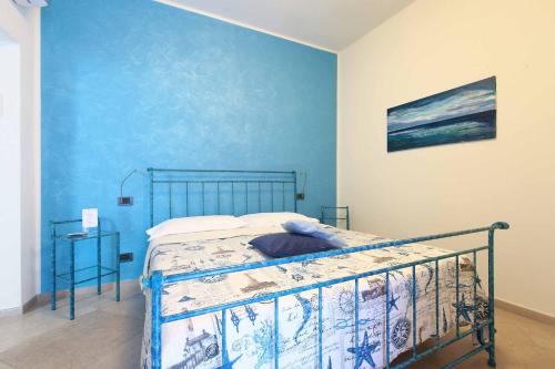 sypialnia z łóżkiem z niebieską ścianą w obiekcie La Rosa Dei Venti w mieście Monterosso al Mare