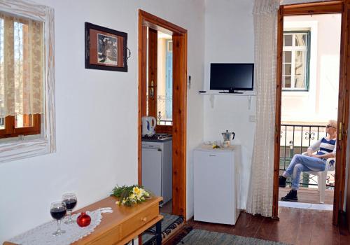 a man sitting in a chair in a living room at Hera Studios in Chania Town