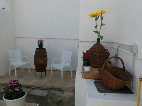 a group of chairs and flowers in baskets on a ledge at Antico Palazzo Spinola in Gallipoli