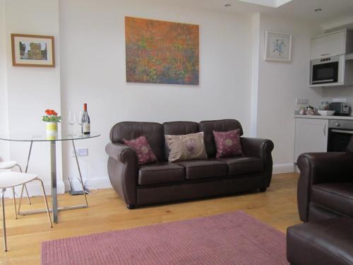a living room with a couch and a table at Temeside Garden House in Ludlow