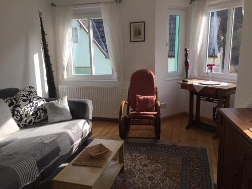 a living room with a couch and a chair at Am Bungert in Mayschoß