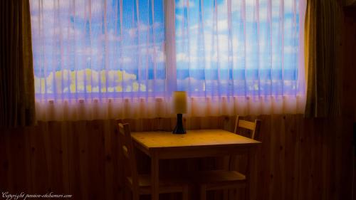 a table with a candle on it in front of a window at Forest West Nishi in Nakijin