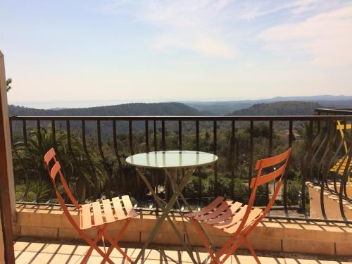 two chairs and a table on a balcony at Les Belles Terrasses in Tourrettes-sur-Loup
