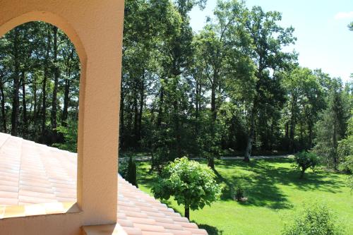 a view of a garden from a house at Maison de Vacances MACOU 2 in Capdrot