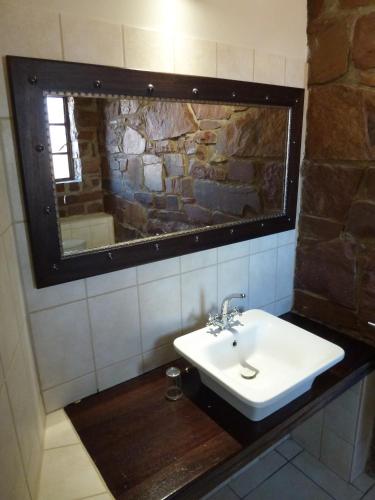 a bathroom with a sink and a mirror at Duwisib Guest Farm in Duwisib