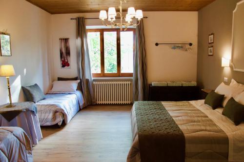 a bedroom with two beds and a window at Suite Umberto I in Assisi