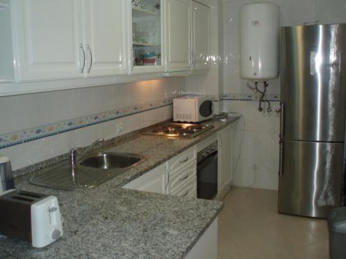 a kitchen with a sink and a refrigerator at Apartment My Site Alvor in Alvor