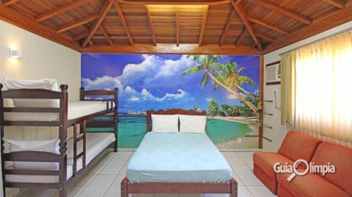 a bedroom with a mural of a beach at Flat Beija-Flor in Olímpia