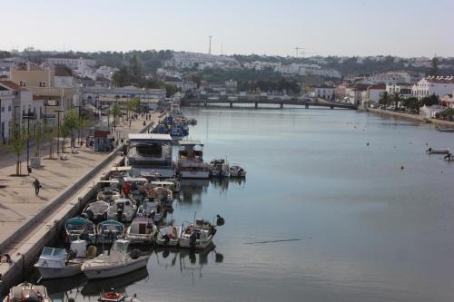 a group of boats are docked in a harbor at Cabanas Green Apartment & Loft. in Cabanas de Tavira