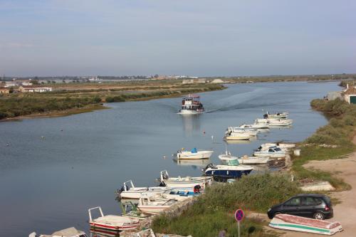 a group of boats are docked in a river at Cabanas Green Apartment & Loft. in Cabanas de Tavira