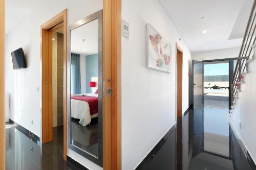 a hallway with a door leading to a bedroom at Sunfield Guest House - Only Adults in Albufeira