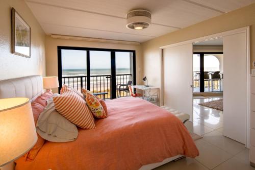 a bedroom with a bed with a view of the ocean at Florence in South Padre Island