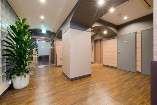an office with a potted plant in a hallway at FLEXSTAY INN Kawasaki Kaizuka in Kawasaki